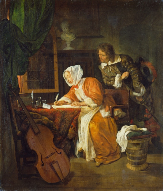 A woman writing at a table while a man leans over her shoulder watching